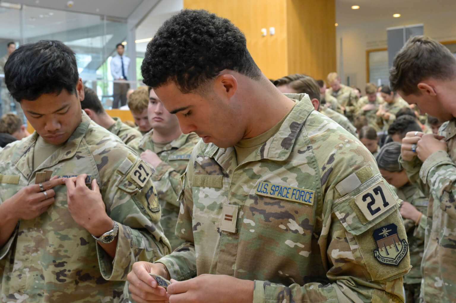 U.S. Air Force Academy Guardian selects replace their Air Force name tape with a Space Force blue name tape during the inaugural Blue Tape Ceremony at Polaris Hall at the U.S. Air Force Academy, Colo., Aug. 17, 2026. The ceremony welcomed Guardian selects and connected them with active-duty Guardian mentors as they prepare to commission into the U.S. Space Force. (U.S. Air Force photo by SSgt Michael Ward)
