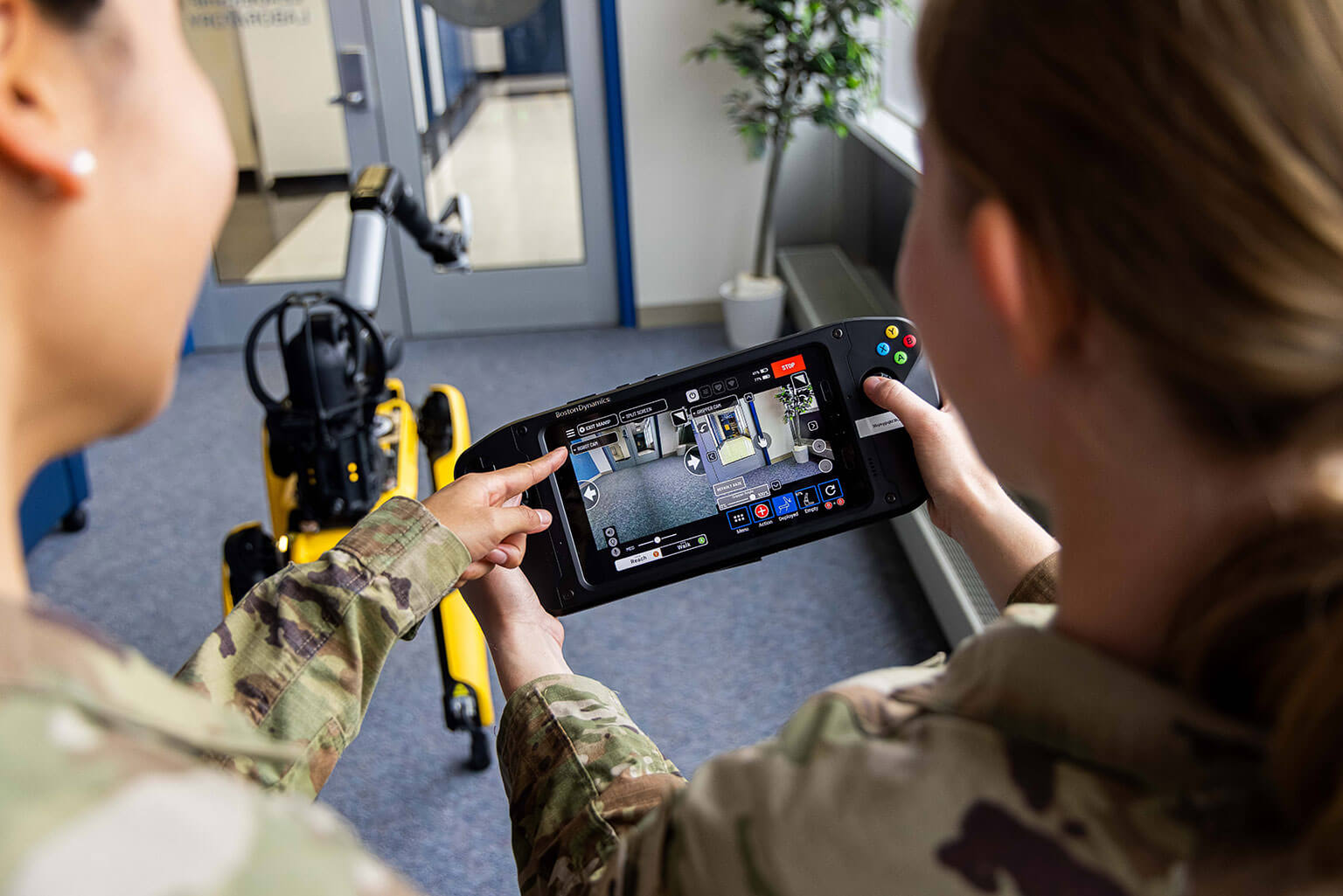 Cadets operate a robotic dog using a remote controller at the U.S. Air Force Academy, Colo., Oct. 14, 2026. The hands-on experience allows cadets to explore controlling robotic systems and their potential applications. (U.S. Air Force photo by Trevor Cokley)
