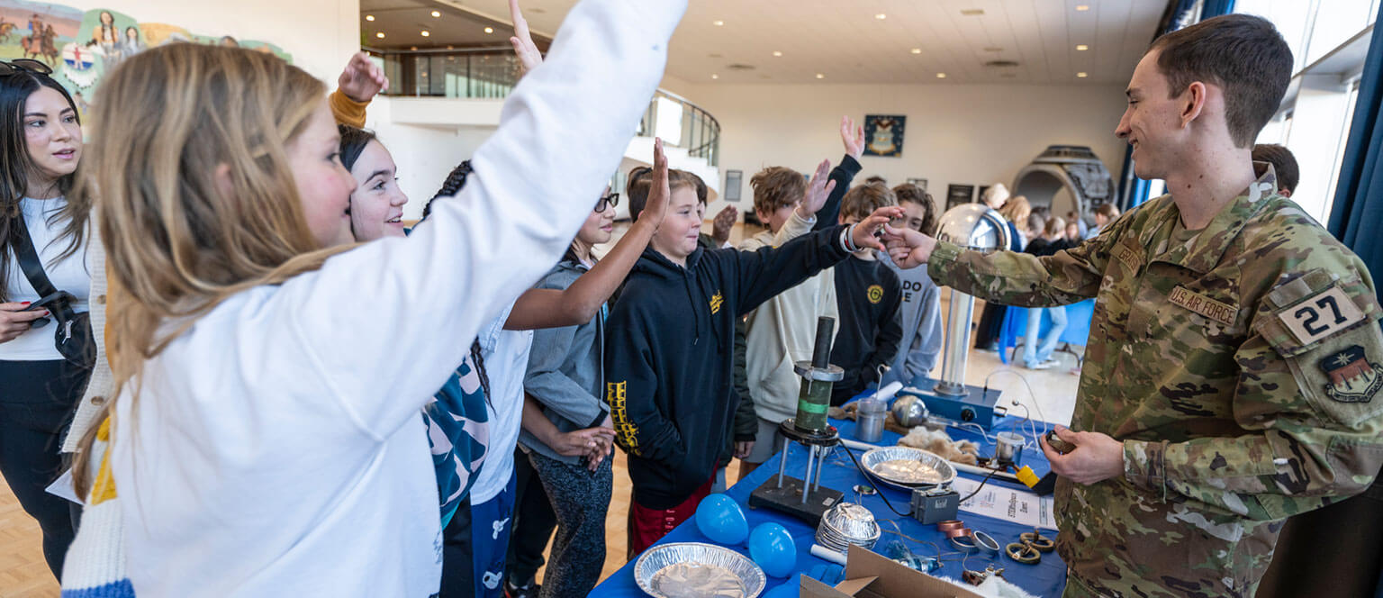 Cadets at booths during the annual STEM Day event.