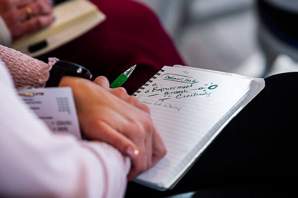 Attendee taking notes at NCLS.