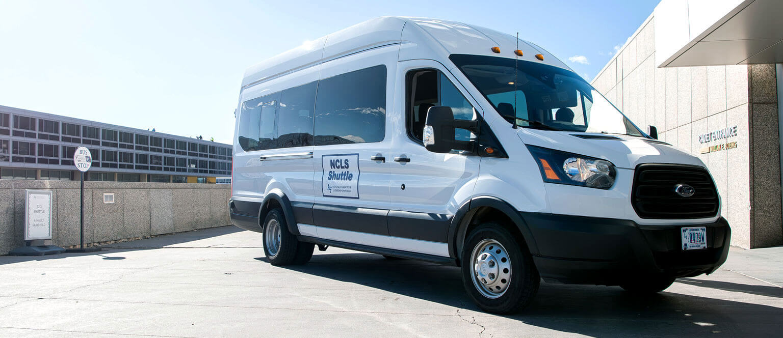 NCLS shuttle van parked in front of bus stop.