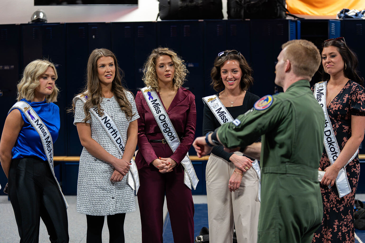 A 306th Flying Training Group officer explains parachute packing procedures to Miss America state delegates.