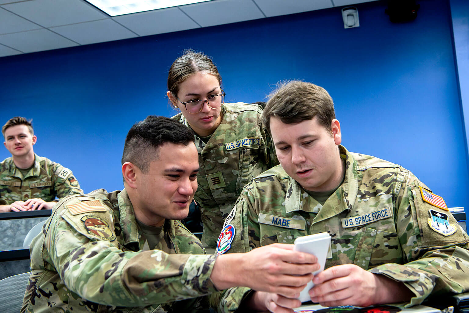 Cadets 1st Class Christopher Lindley, left, Trevin Mabe, and Isiskyra Budd watch an exercise on market sizing and analysis.