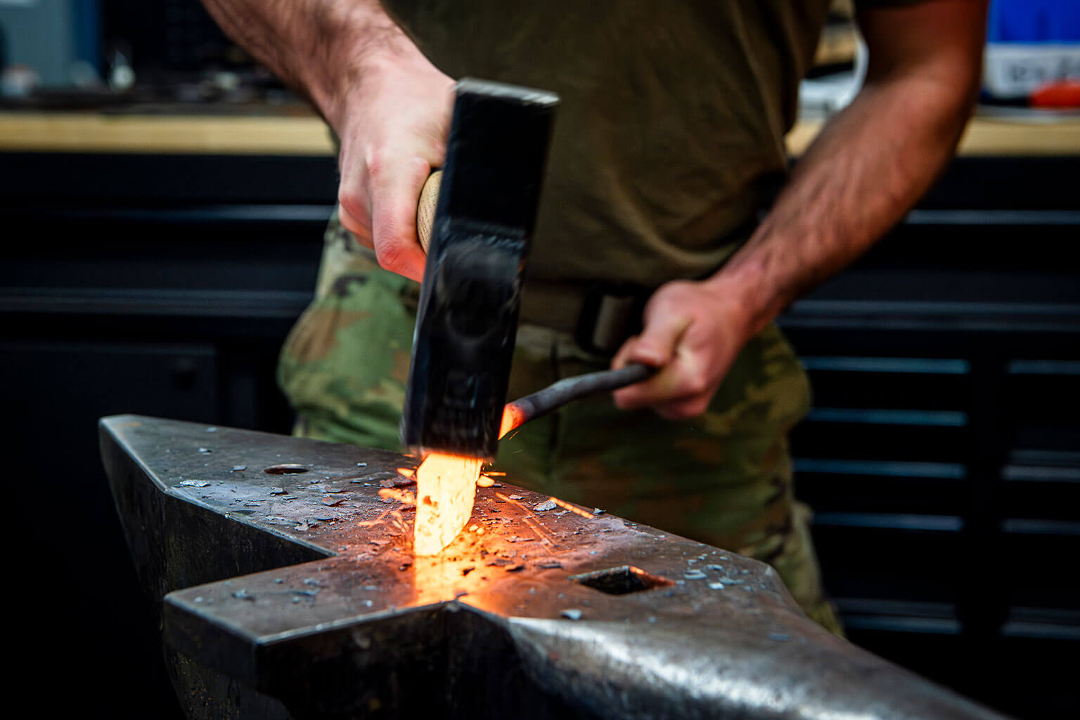 Cadet 1st Class Ryan Hebert lowers the hammer on the knife he made for the 2024 Minerals, Metals and Materials Society Bladesmithing Competition.