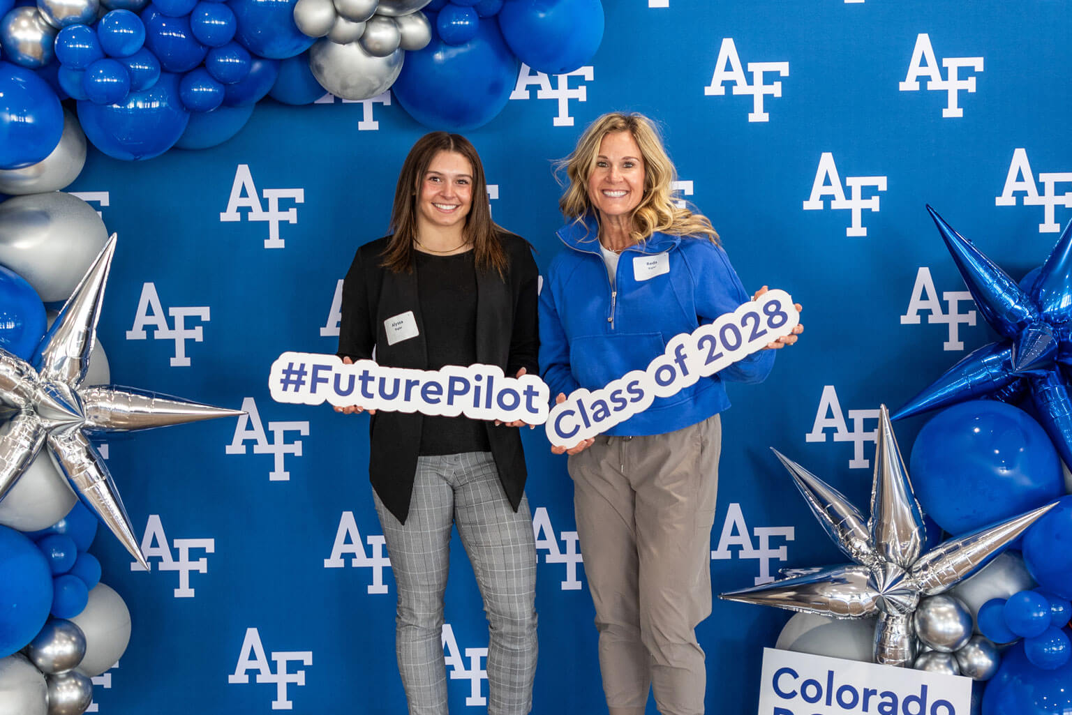 U.S. Air Force Academy appointee Alyssa Bigler poses with her mother Reda in the admissions photo booth in Arnold Hall.