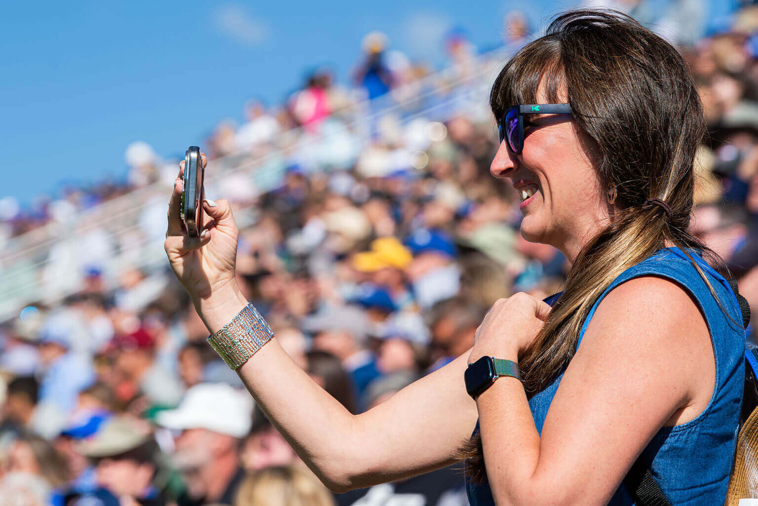 A parent taking video of during the Parents' Weekend Parade that happens over Labor Day weekend. A parent taking video of during the Parents' Weekend Parade that happens over Labor Day weekend.