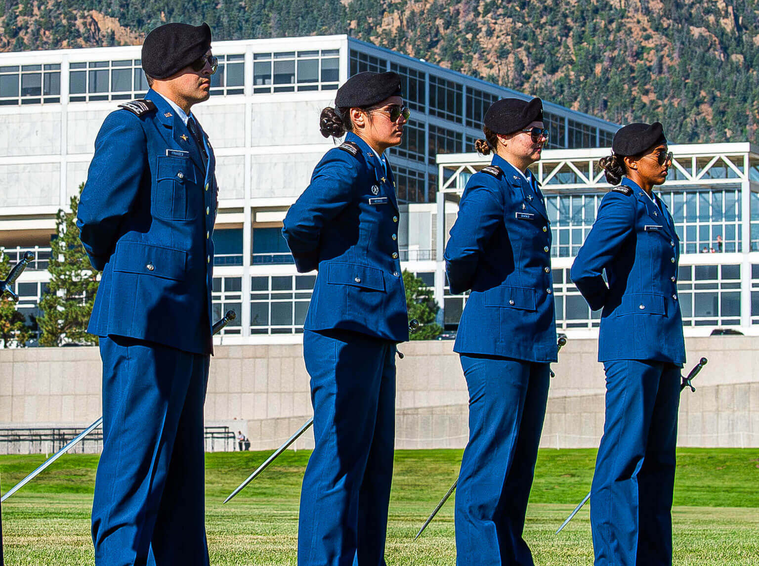 Four cadets standing on Stillman Field during the Parents's Weekend Parade. Four cadets standing on Stillman Field during the Parents's Weekend Parade.
