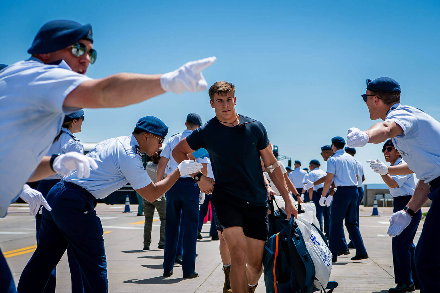 A Basic Cadet walking quickly through a gauntlet of cadet cadre. A Basic Cadet walking quickly through a gauntlet of cadet cadre.