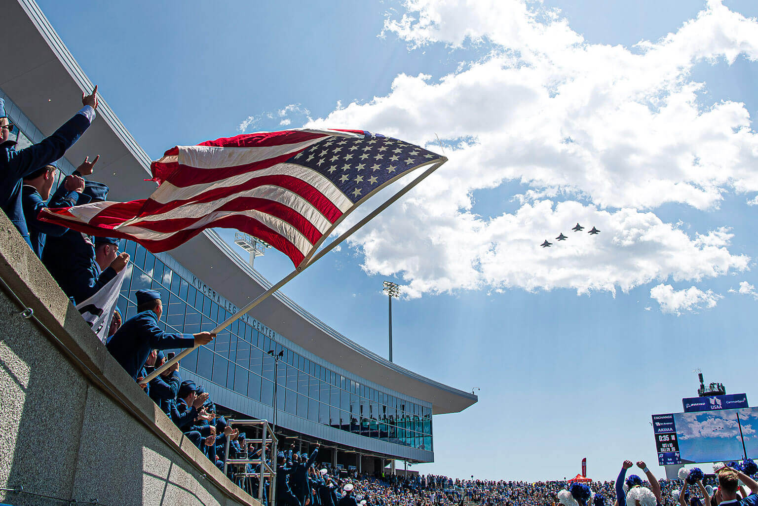 A formation of four planes performing a fly-over at Falcon Stadium during a football game during Parents' Weekend. A formation of four planes performing a fly-over at Falcon Stadium during a football game during Parents' Weekend.