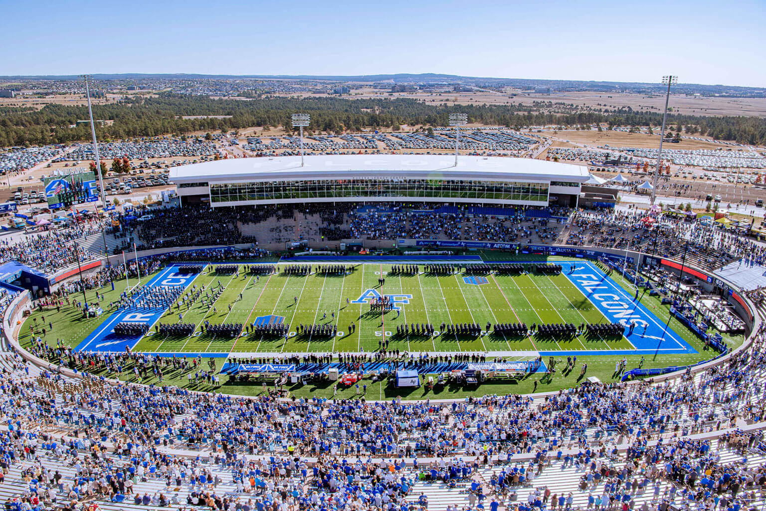 Cadets in formation on the field during a football game at Falcon Stadium. Cadets in formation on the field during a football game at Falcon Stadium.