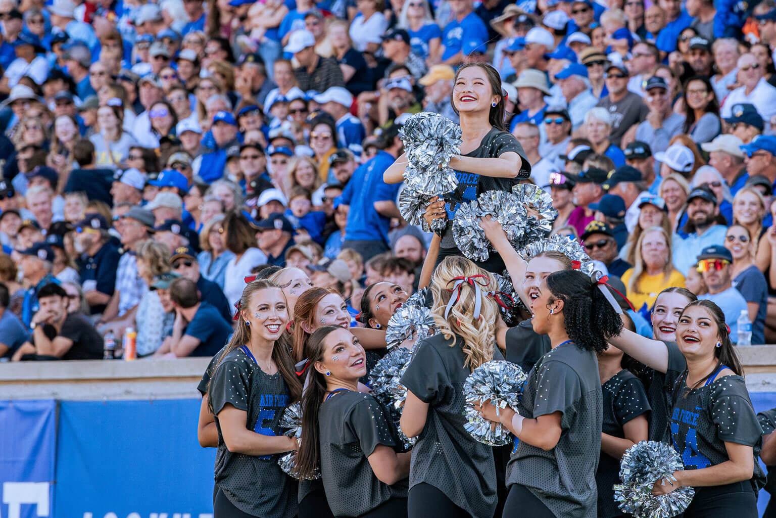 Cheerleaders performing at Falcon Stadium during a football game. Cheerleaders performing at Falcon Stadium during a football game.