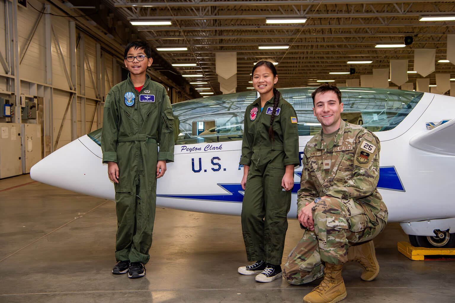 Then-Cadet 1st Class Mark Carnes, Class of 2025, with Cadet for a Day Peyton Clark and her brother, Elijah Clark, at the Davis Airfield.