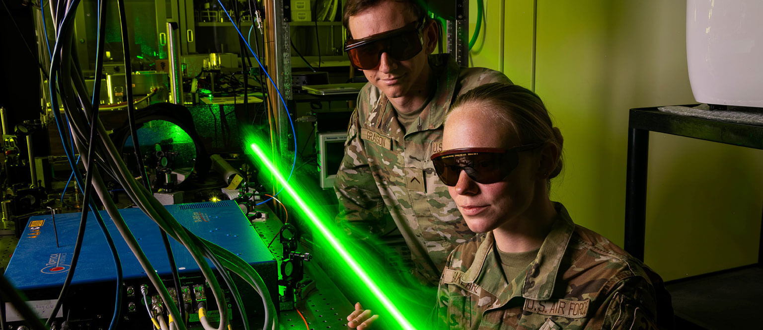Cadets conducting a experiment with a laser.