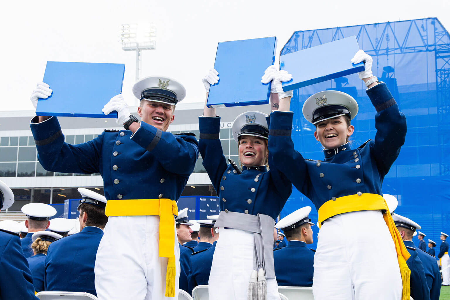 Cadets hoist their diplomas during the U.S. Air Force Academy Class of 2025 graduation ceremony.