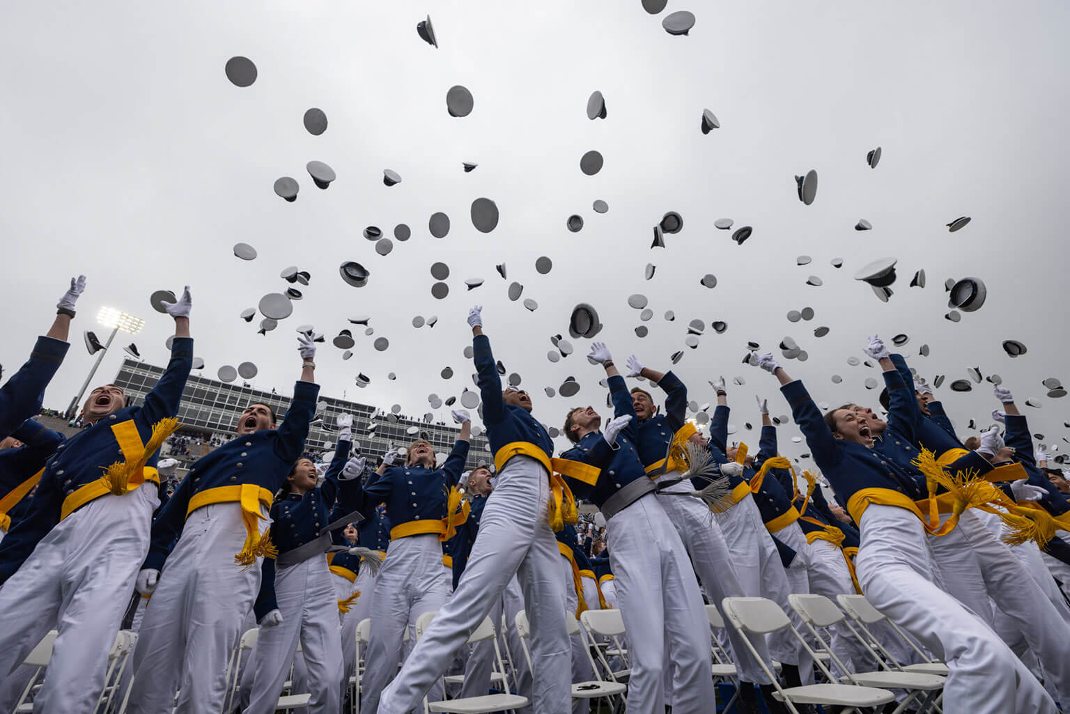 U.S. Air Force Academy Class of 2025 graduates toss their hats skyward in Falcon Stadium, May 29, 2025. The Class of 2025 includes 791 cadets who were commissioned into the Air Force, and 93 were commissioned into the Space Force as second lieutenants. (U.S. Air Force photo by 2d Lt Brandon Lindner)