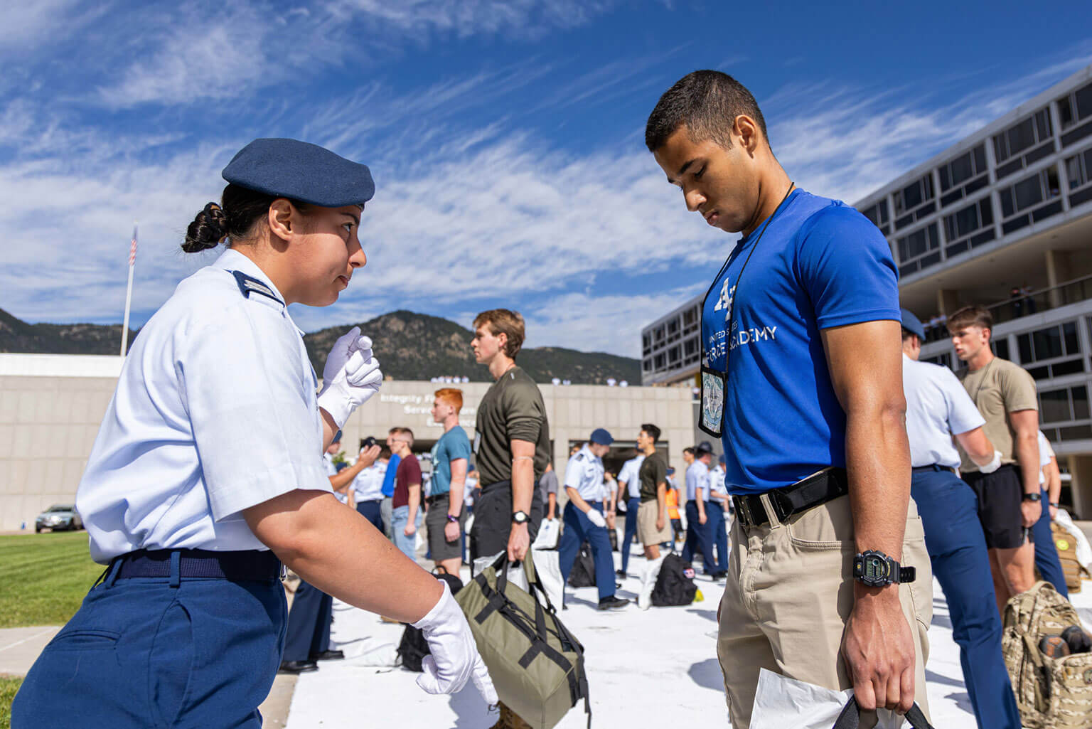 A Class of 2029 basic cadet is learning to stand at attention on one of the footprints at the base of the core values ramp, U.S. Air Force Academy, Colo., June 25, 2025. He is receiving instructions and guidance from a member of the cadet cadre. 