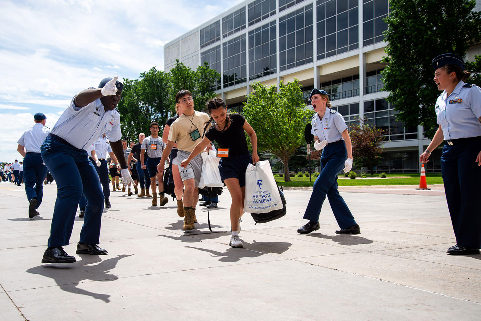 Basic cadets go through a gauntlet of cadre on their way to the footprints. They basics are told to hurry up. (U.S. Air Force photo by Adalyn Greene)