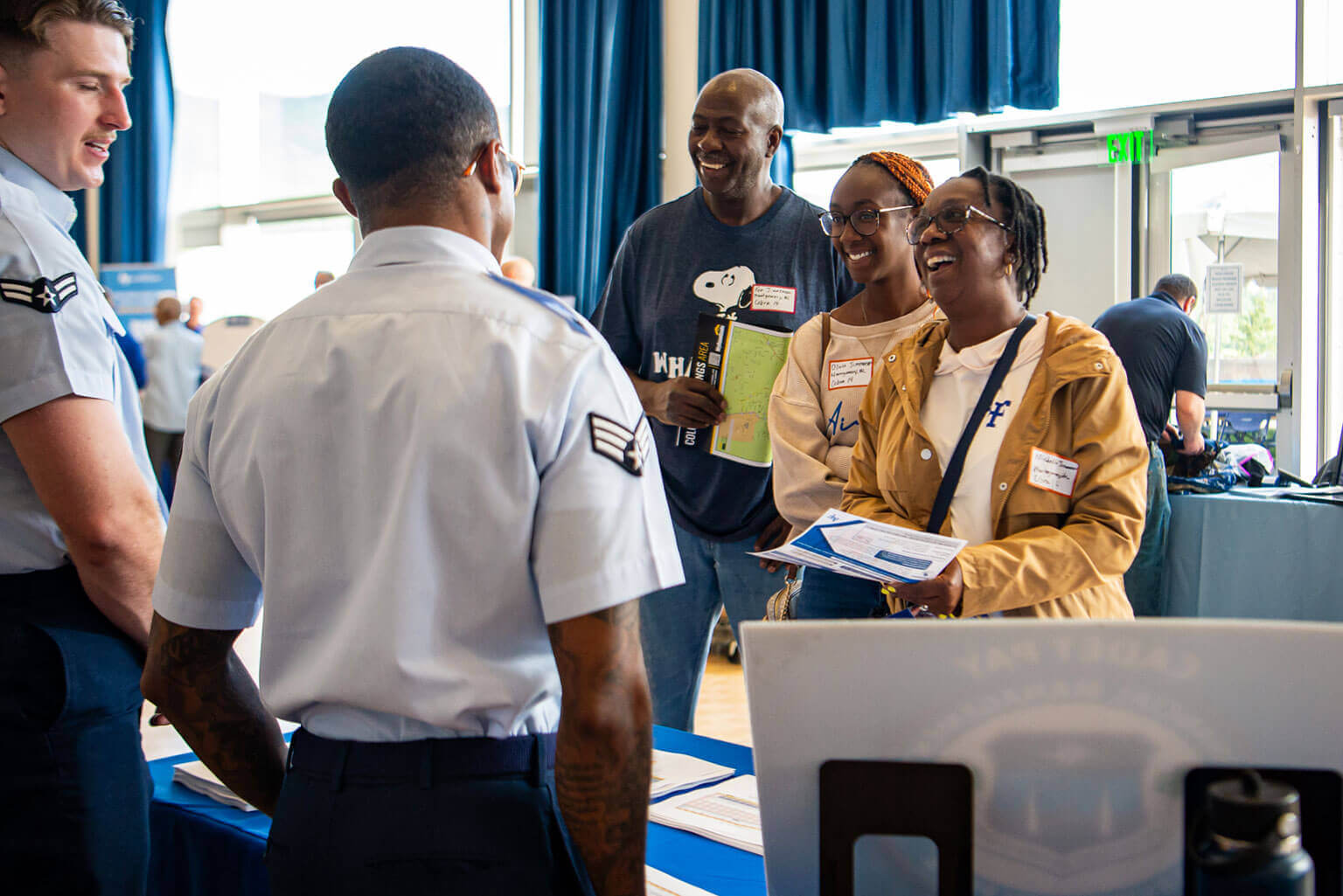 Airmen talking to cadet parents at the Parents' Weekend Information Fair. Airmen talking to cadet parents at the Parents' Weekend Information Fair.