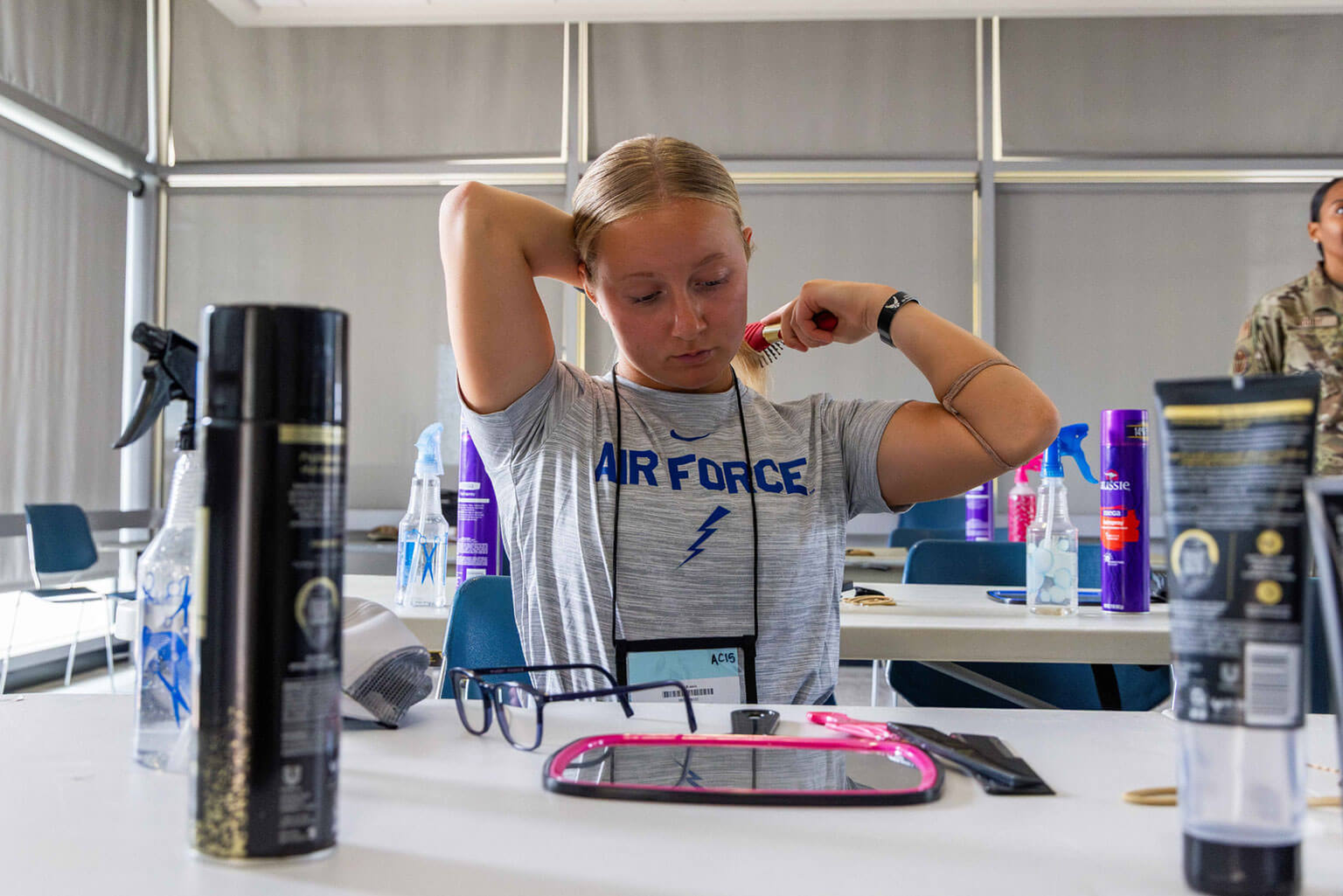Female basic cadets receive instruction on Air Force hairstyles. (U.S. Air Force photo by Trevor Cokley)