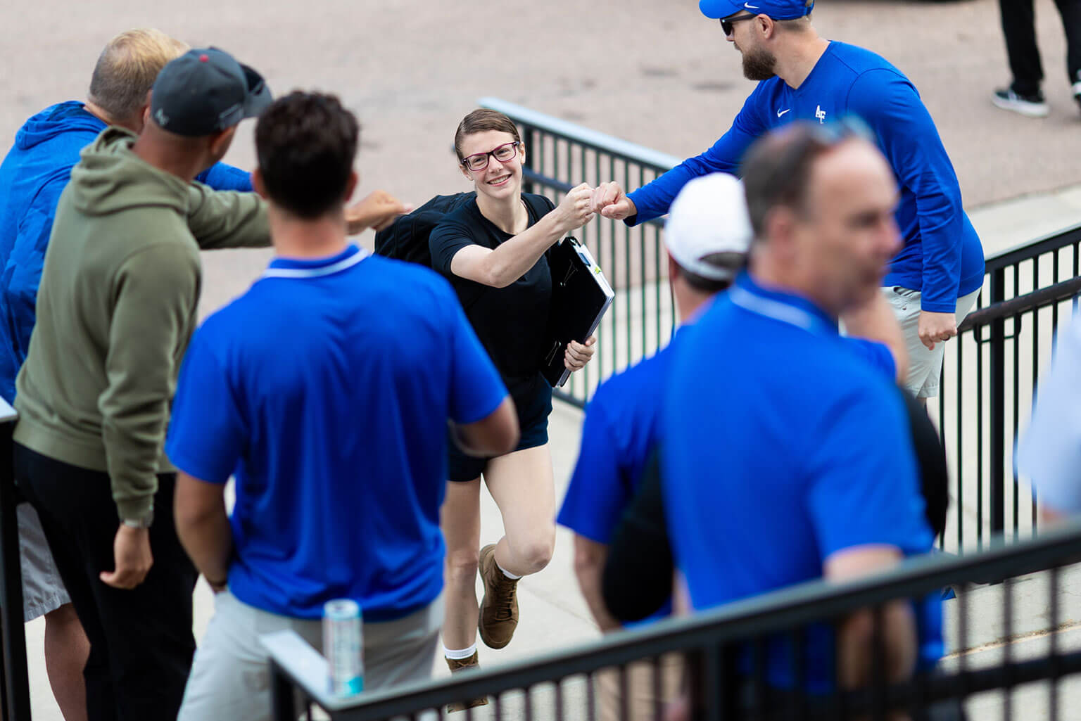 An appointee fist bumps a faculty member as she walks up the stairs of the Holaday Athletic Center. This is the first step in her journey toward becoming a second lieutenant in the Air Force or Space Force. (U.S. Air Force photo by Ray Bahner)