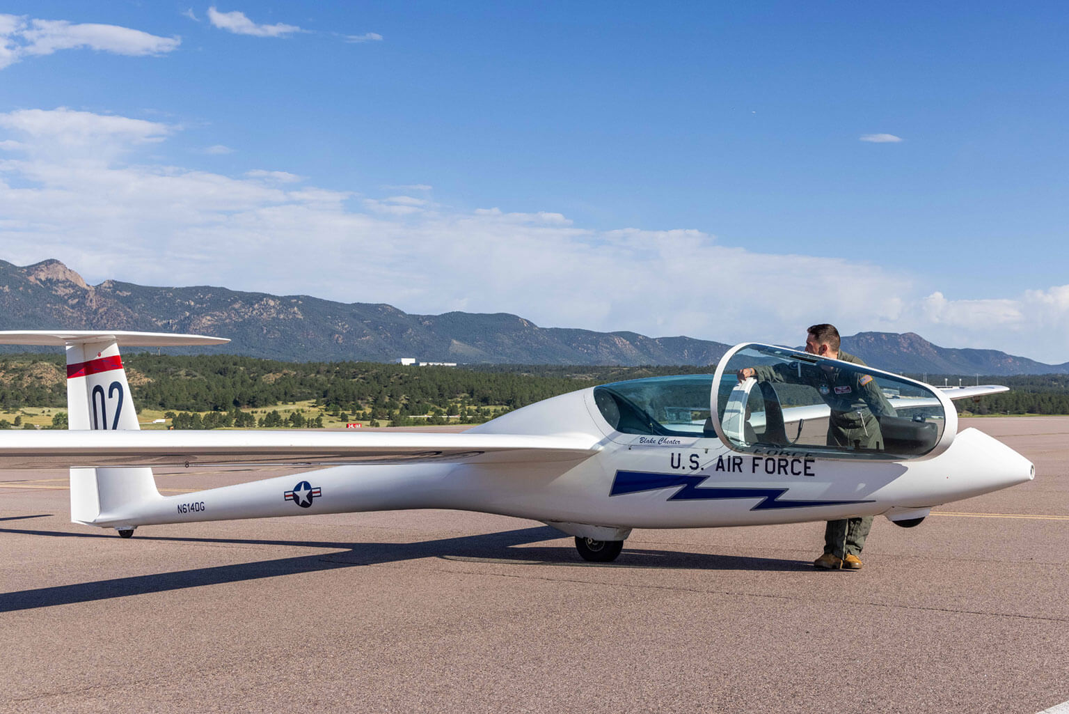 Cadet 1st Class Steven Newcomer requests clearance from the tower to go onto the center runway to be able to take off, Davis Airfield, U.S. Air Force Academy, Colo., July 8, 2025. Newcomer is an instructor pilot in the basic soaring program, Airmanship 251. (U.S. Air Force photo by Trevor Cokley)