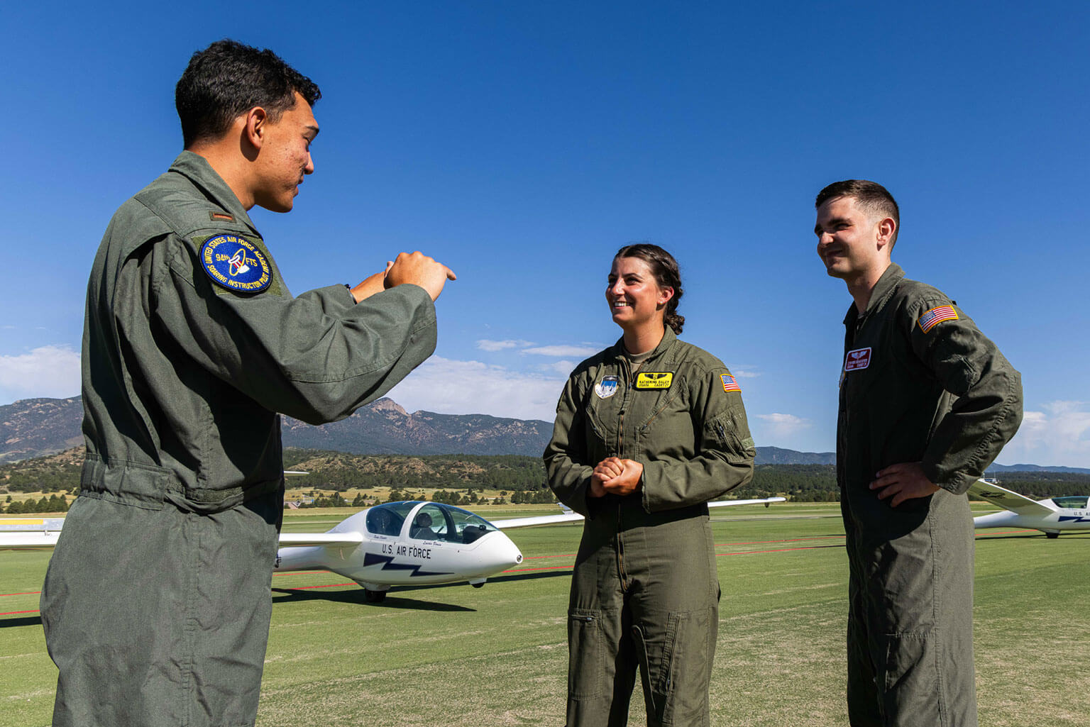 Cadet 2nd Class Katherine Daley, center, and Cadet 1st Class Steven Newcomer, right, receive information from 2nd Lt Joshua Richards about a runway change, Davis Airfield, U.S. Air Force Academy.