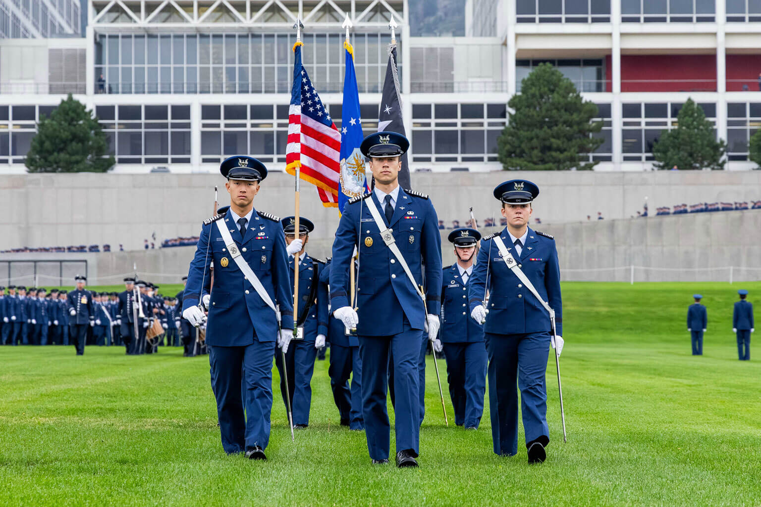 Cadet 1st Class Avery Tan, vice commander; Cadet 1st Class Robert (Jake) Miller, commander; and Cadet 1st Class Angelina Harris, chief of staff, Cadet Wing, lead the Parents' Weekend Parade at the U.S. Air Force Academy, Aug. 29, 2025. Held over Labor Day weekend, the event provides activities designed to orient families and visitors to their cadet’s life in the military.  (U.S. Air Force photo by Trevor Cokley)