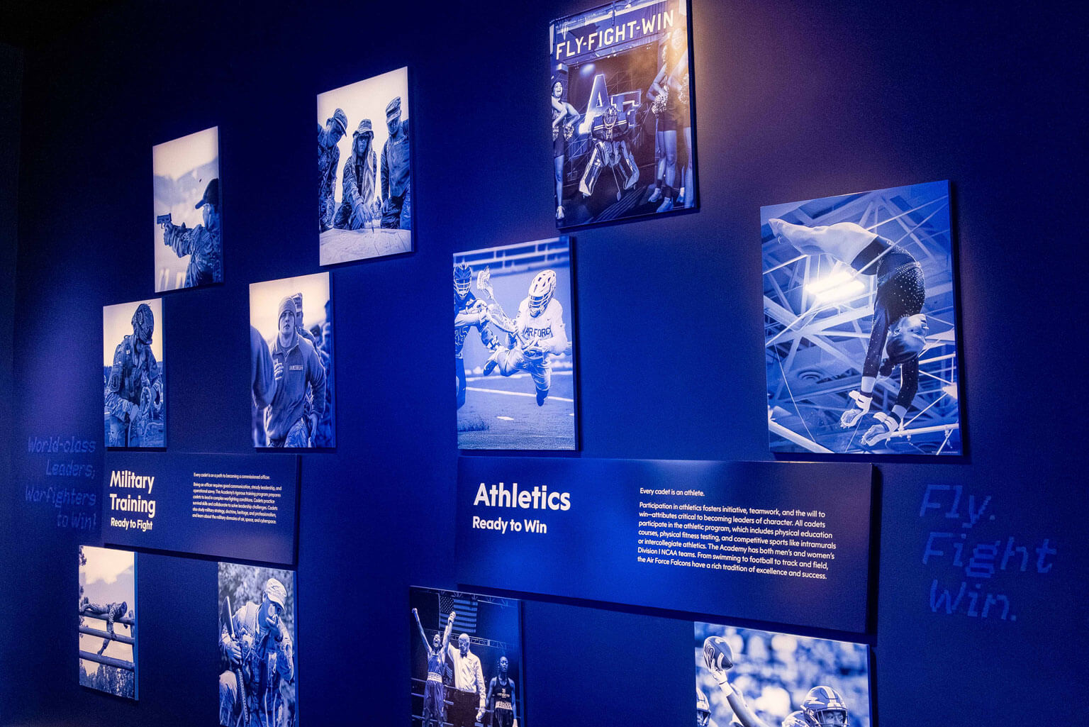 Blue and white photographs of athletes displayed in the exhibit, showcasing their dynamic movements and expressions.