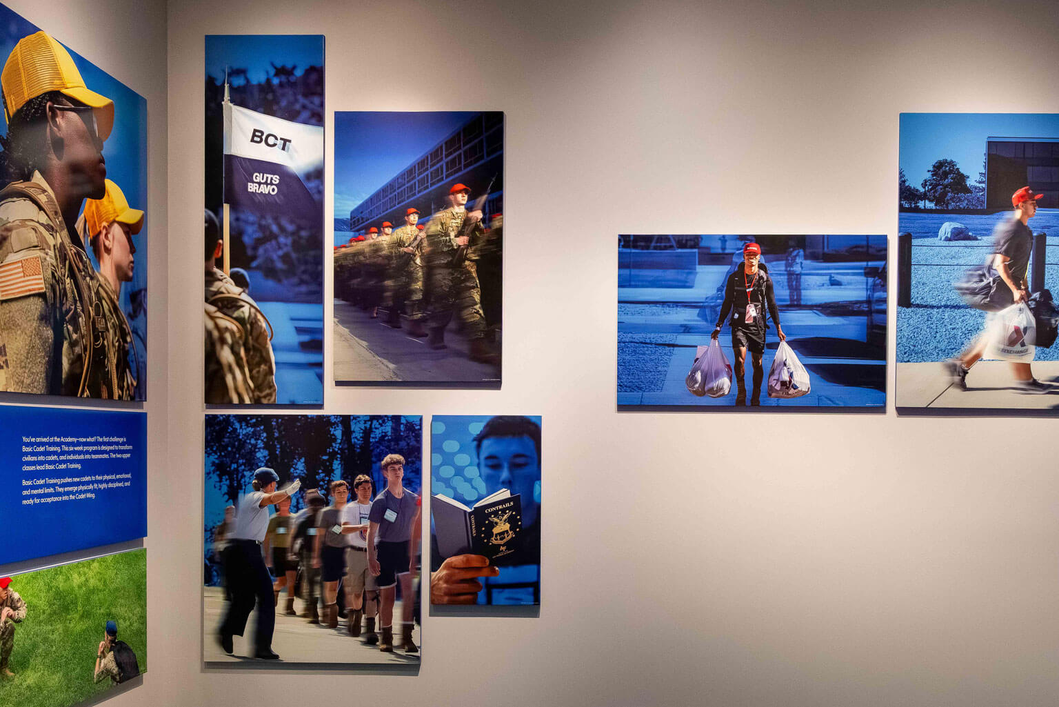 Cadet BCT training photos on a wall, featuring cadet appointees walking and standing in front of the displayed images.