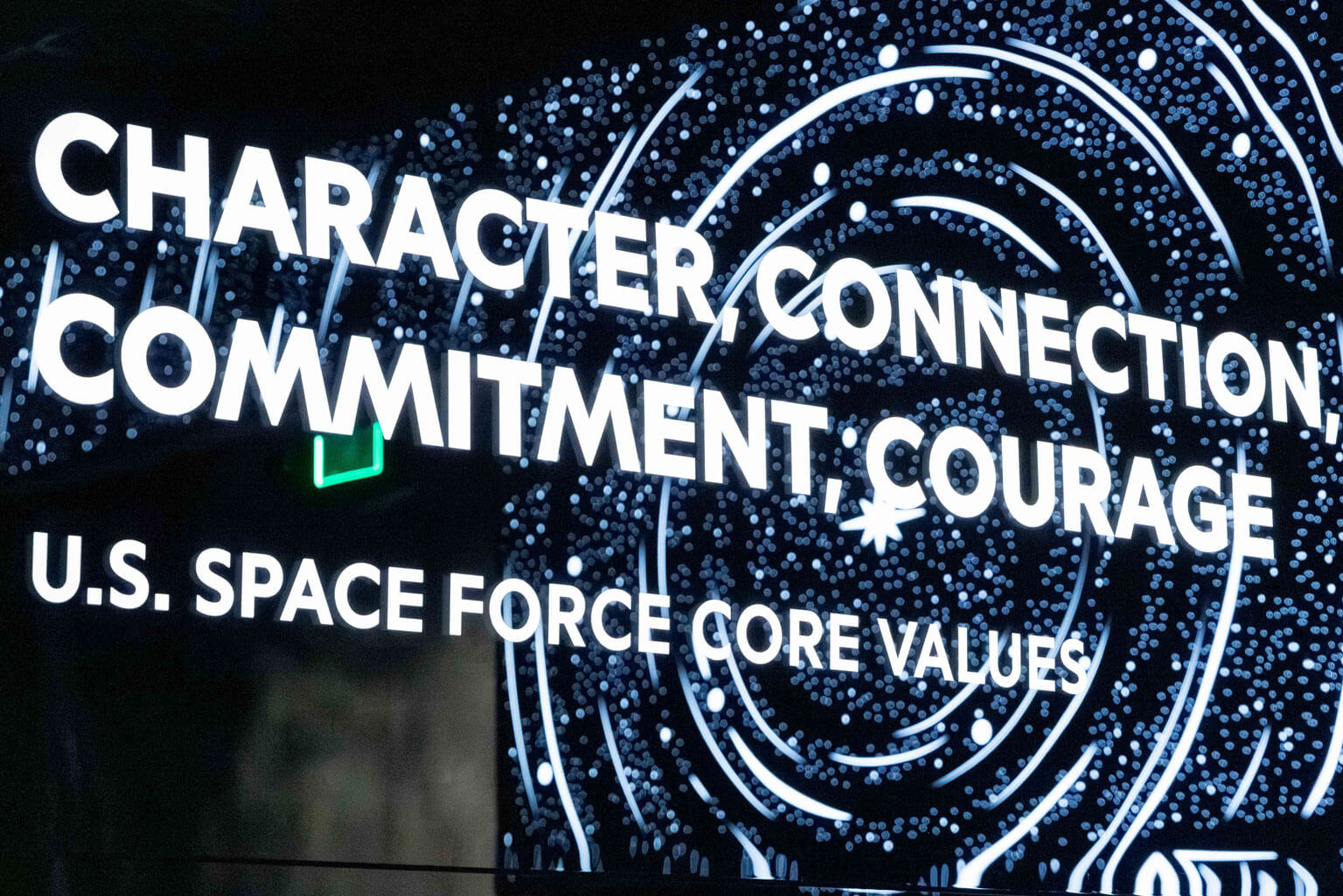 A sign displaying the U.S. Space Force core values: character, connection, commitment, and courage.