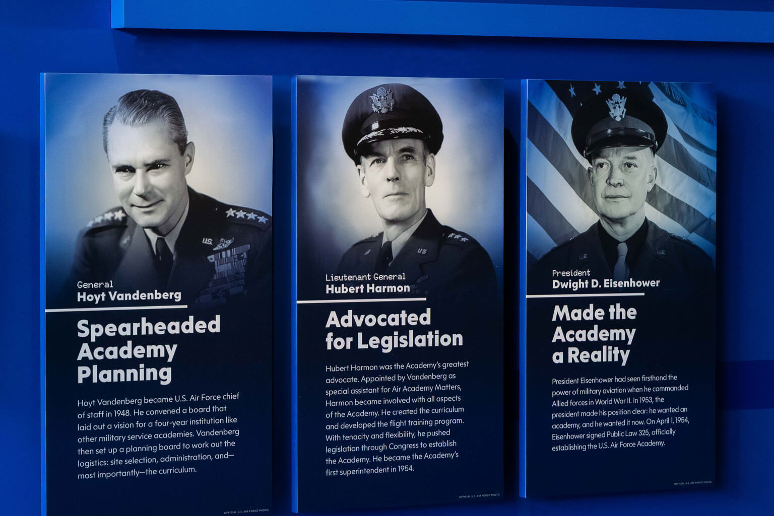 Wall display of three posters showcasing General Hoyt Vandenberg, Lieutenant General Hubert Harmon, and President Eisenhower.