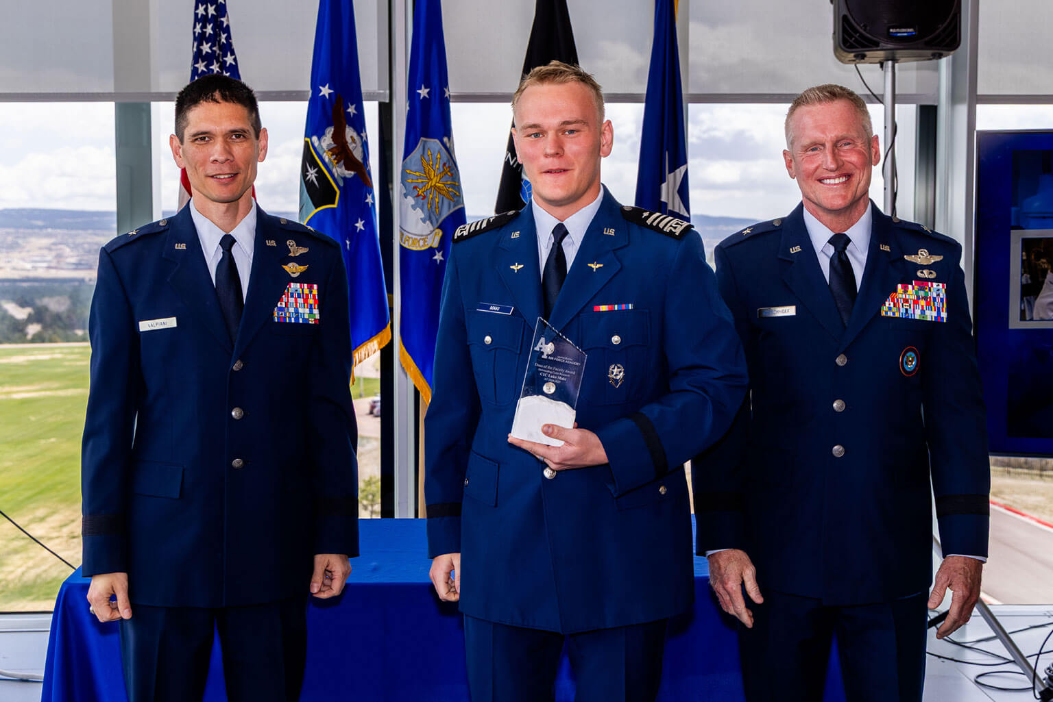 Brig. Gen. James M. Valpiani, dean of the faculty, left, Cadet 1st Class Luke Maki, center, and Brig. Gen. Jason Rueschhoff, right, pose for a photo during the Academy Research Showcase at the U.S. Air Force Academy, Colo., April 28, 2026. Maki received the Dean of the Faculty Award for Outstanding Cadet Research. (U.S. Air Force photo by Trevor Cokley) 