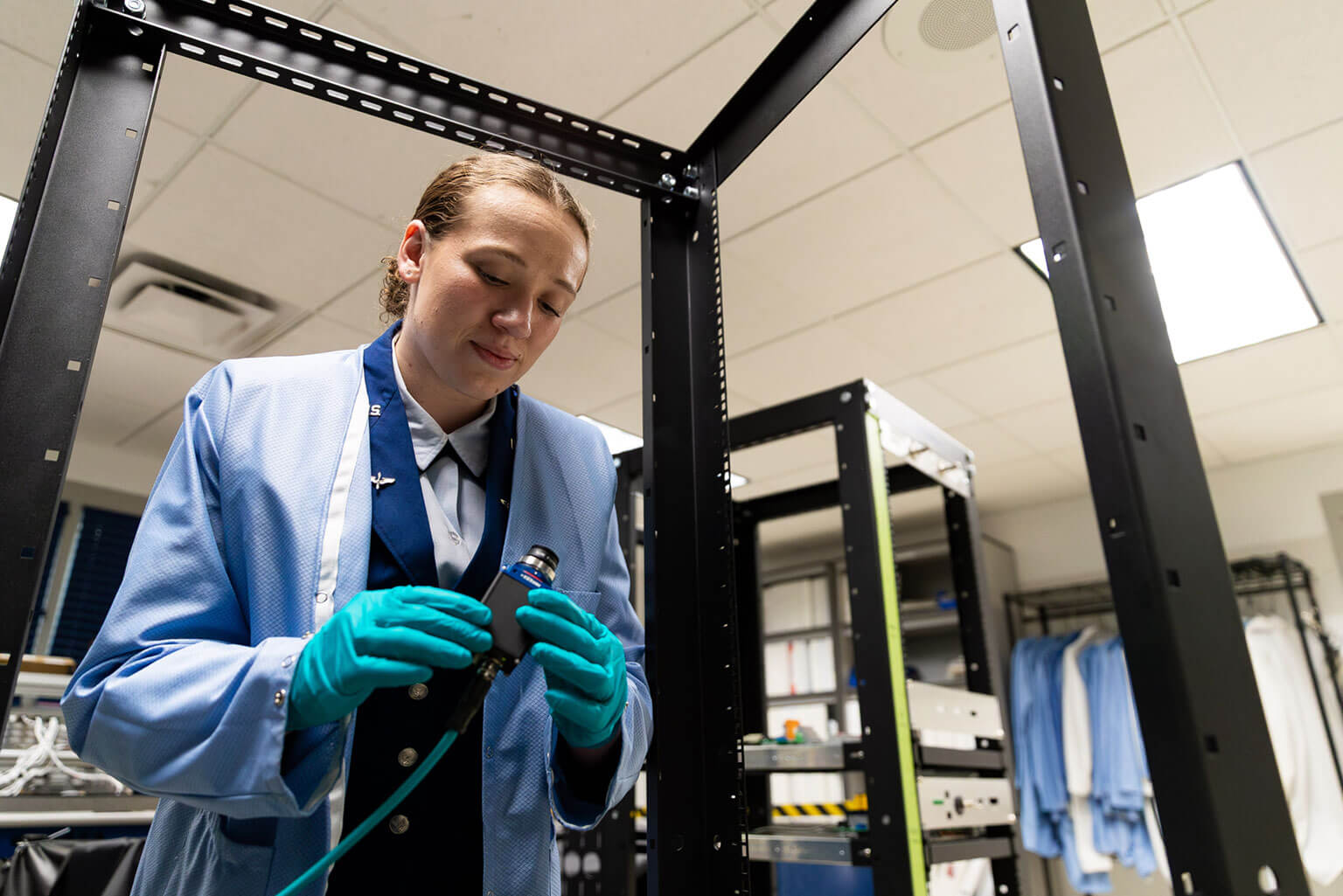 Cadet 1st Class Emma Sanchez checks the connection for a star tracker camera before conducting a test at the U.S. Air Force Academy, Colo., May 6, 2026. The camera supports the FalconSAT program by helping operators determine a satellite's position and guide its movement during the mission. (U.S. Air Force photo by Ray Bahner)