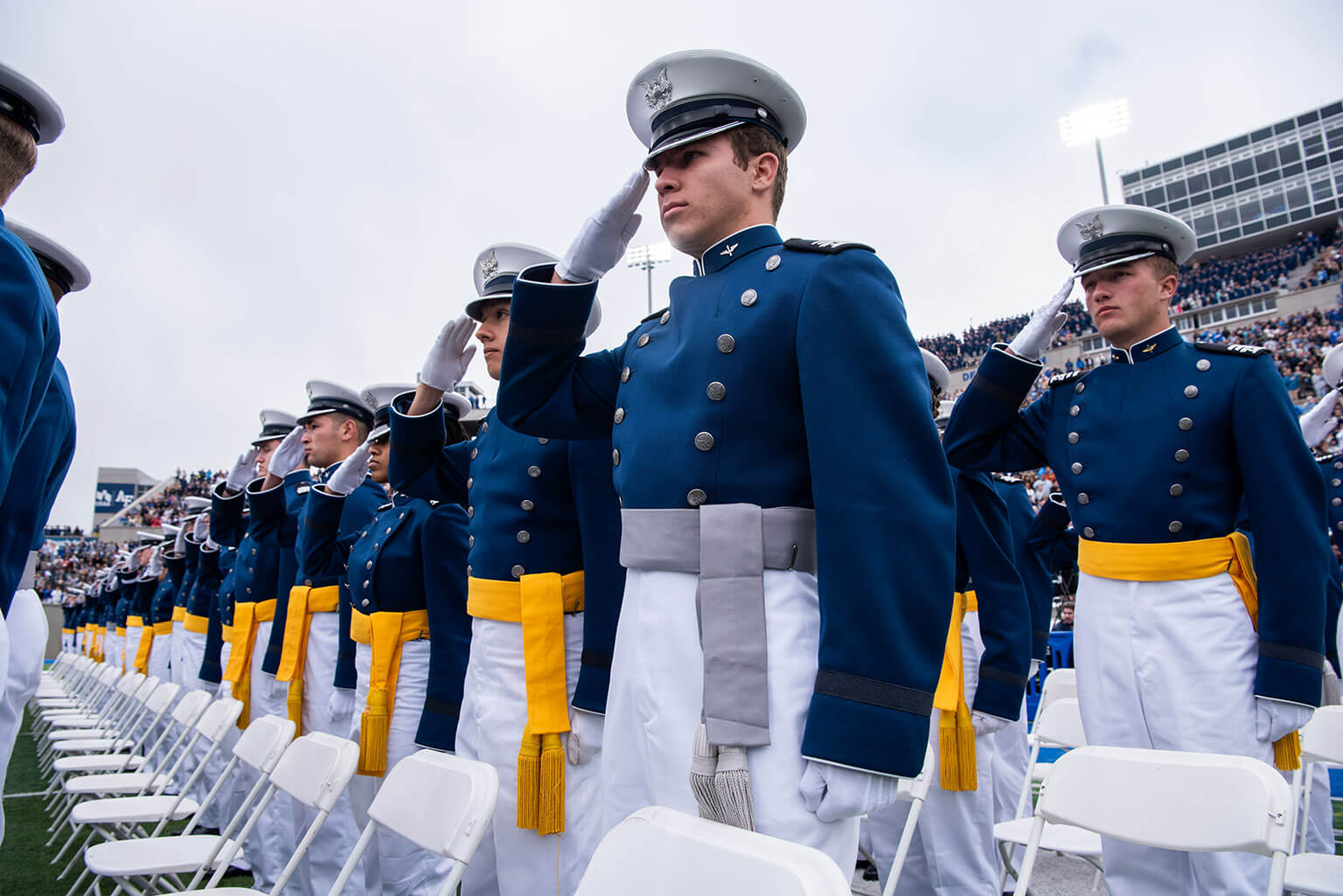 Cadets salute during the U.S. Air Force Academy Class of 2026 Graduation Ceremony at Falcon Stadium on the Academy, Colo., May 28, 2026. Forged through 47 months of military training, academics, athletics and character development, the graduates are prepared to lead in complex and contested environments. (U.S. Air Force photo by Trevor Cokley)