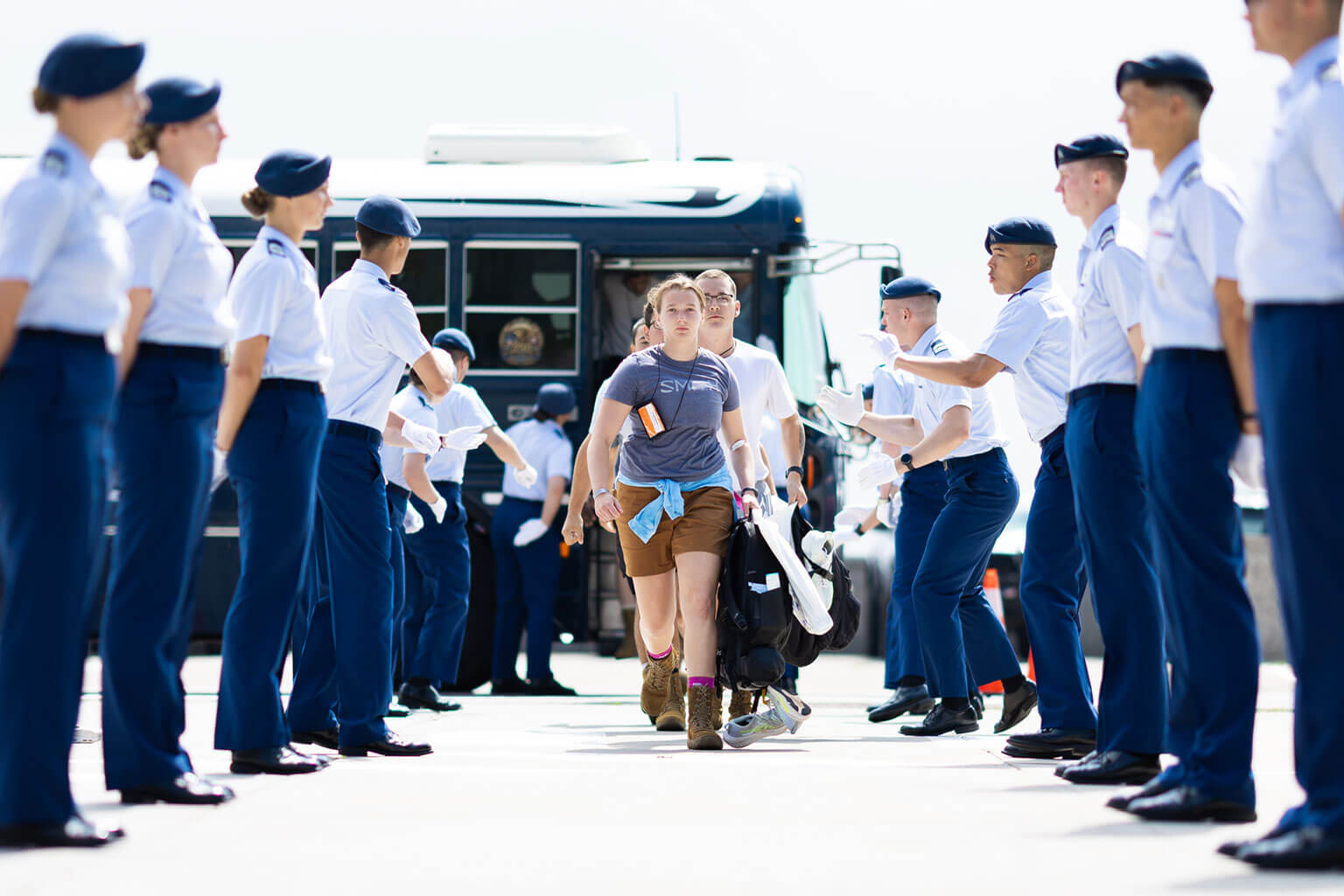 Basic cadets go through a gauntlet of cadre as they step off the bus on their way to the footprints at the U.S. Air Force Academy, Colo., June 24, 2026. The encounter marks one of their first introductions to the pace and discipline of Basic Cadet Training. (U.S. Air Force photo by Ray Bahner)