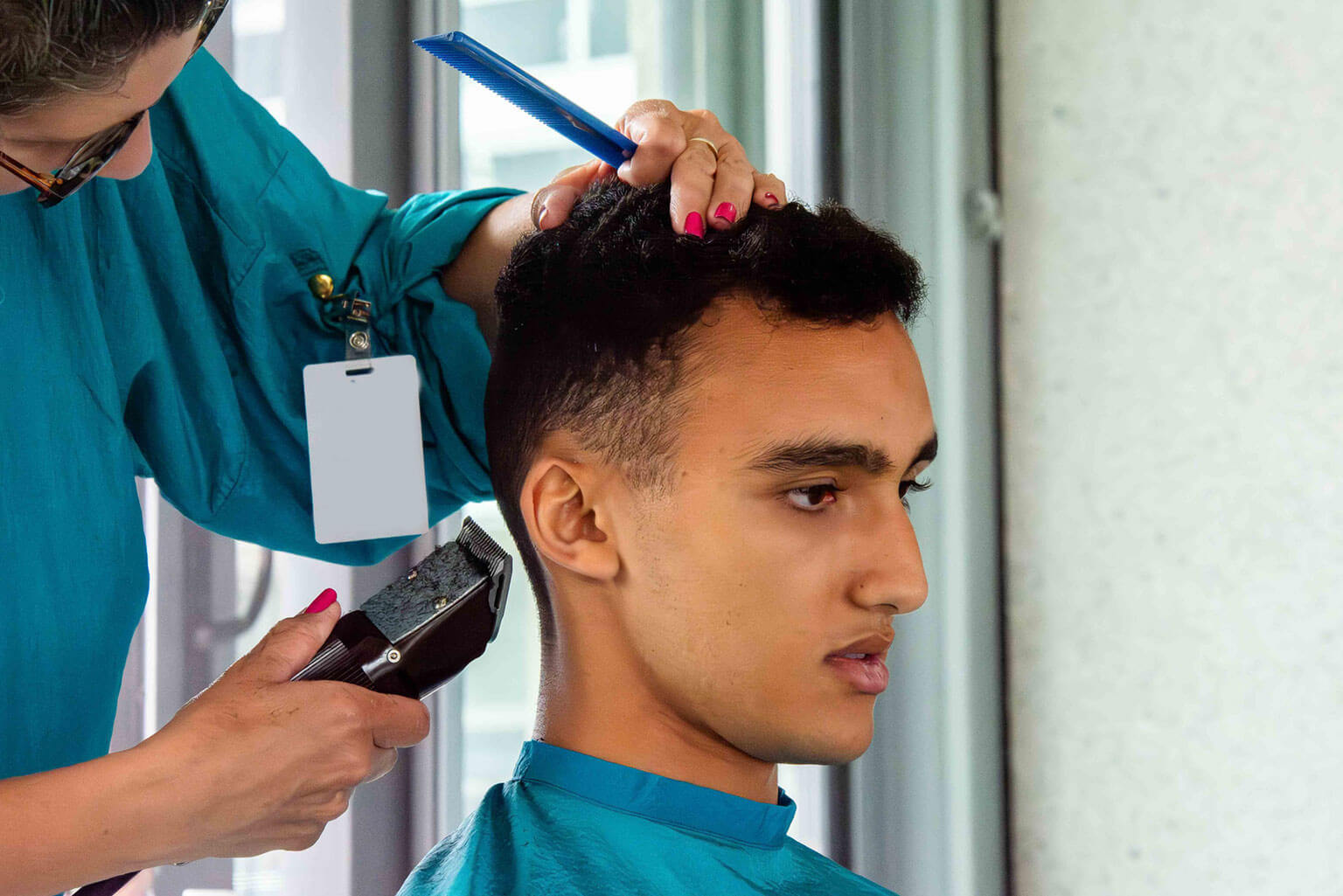 A male basic cadet from the Class of 2030 receives a regulation haircut on In-processing Day at the U.S. Air Force Academy, Colo., June 24, 2026. The haircut is one of the first steps in the transition from civilian life to military training during Basic Cadet Training. (U.S. Air Force photo by Adalyn Greene)