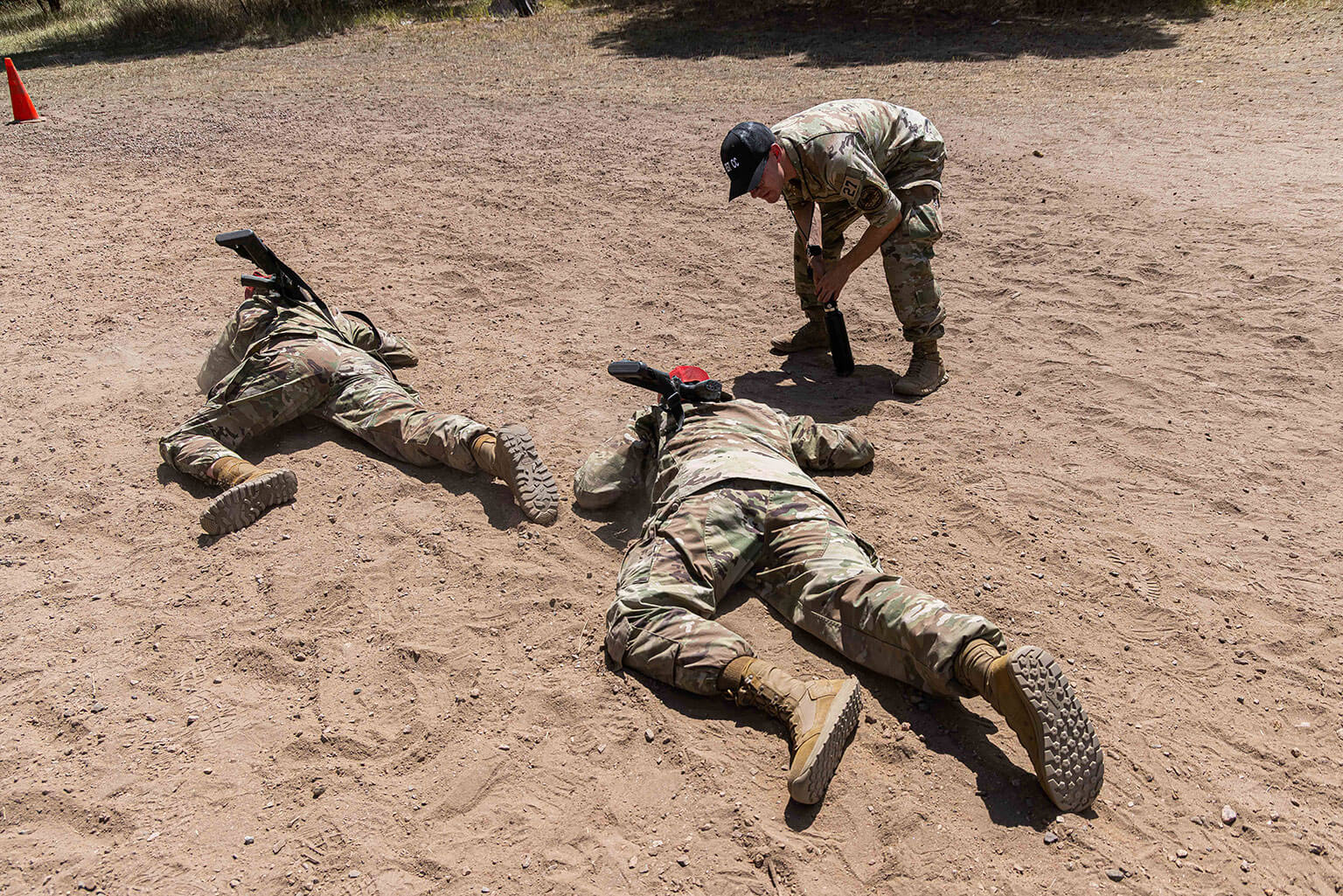 Cadet 2nd Class Gavin Ehrich guides basic cadets through a low-crawl exercise during Foundational Expeditionary Skills Training at the U.S. Air Force Academy, Colo., July 16, 2026. The exercise teaches cadets to move under simulated threats while maintaining control of their rifles. (U.S. Air Force photo by Trevor Cokley)
