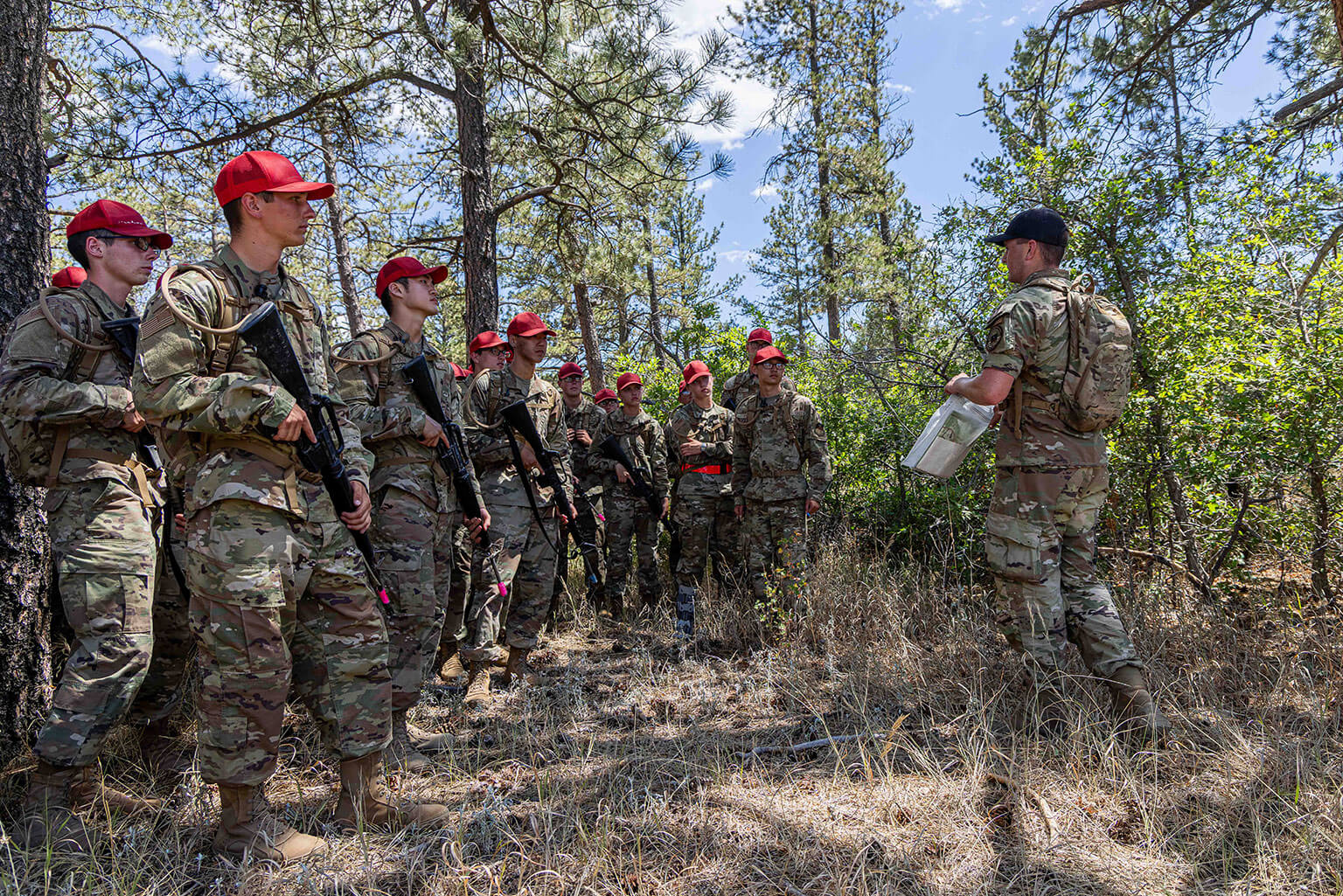 A cadre member briefs basic cadets ahead of Foundational Expeditionary Skills Training at the U.S. Air Force Academy, Colo., July 20, 2026. Cadre brief basic cadets on required equipment and expectations before they enter the field. (U.S. Air Force photo by Trevor Cokley)