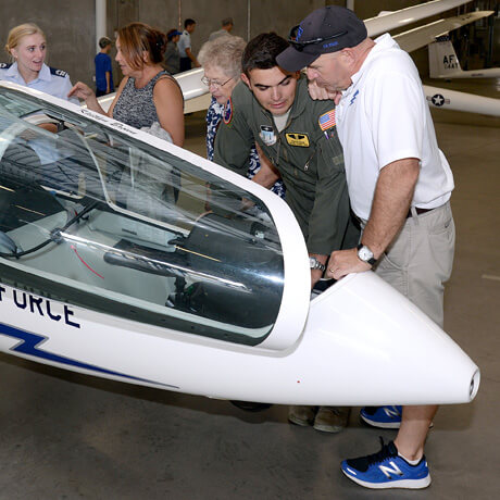 Cadet speaks with a participant at the Parents' Weekend Air Field Open House.