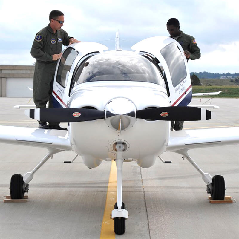 Cadets inspect an airplane on the Academy runway.