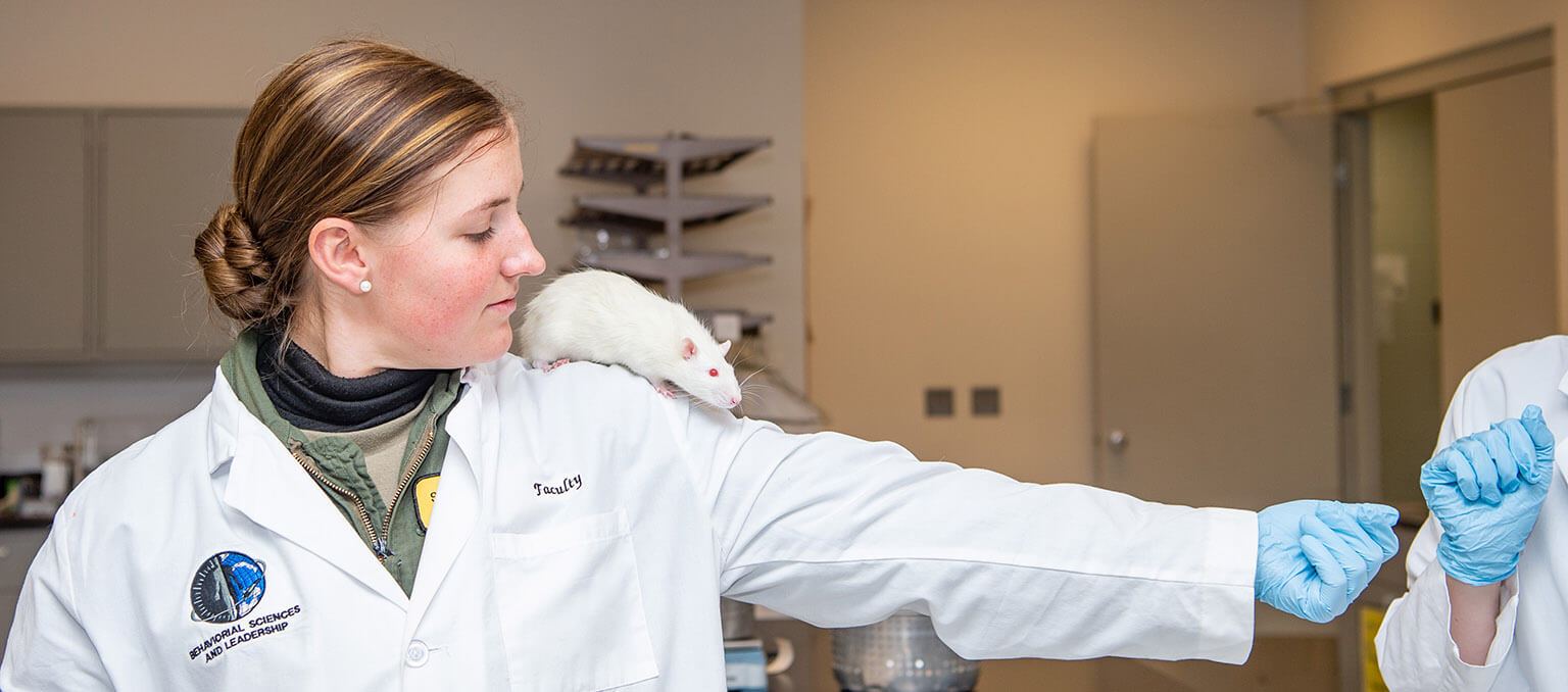 Person with white lab rat on shoulder