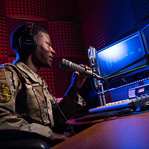 Cadet at microphone and console