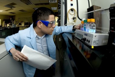 Cadet examines liquids in a chemistry lab