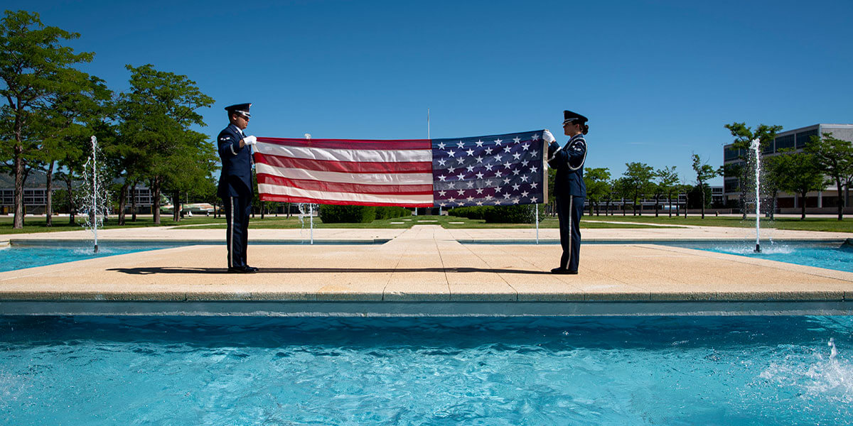 Cadet Honor Guard members folding flag