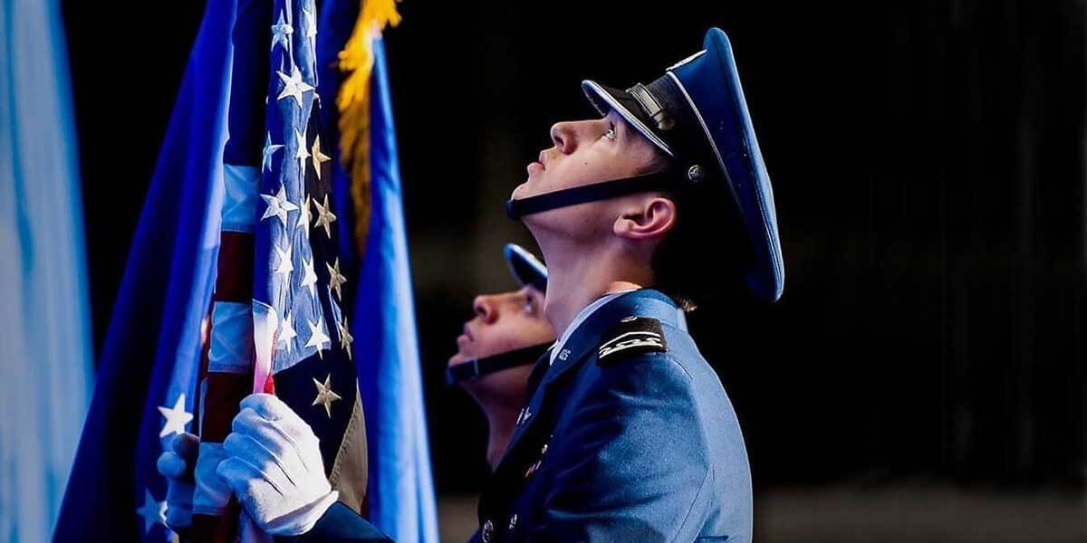 Members of Cadet Honor Guard looking up at flags