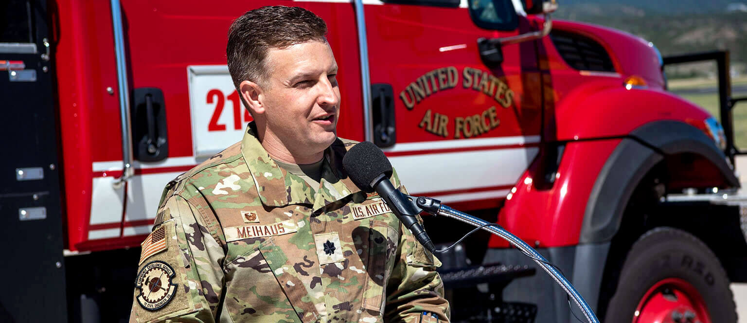 Fire fighter talks to people from a podium