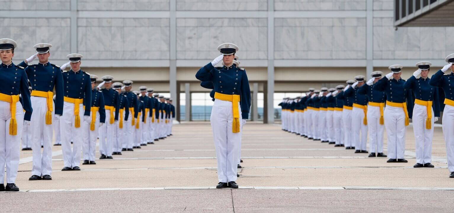 Cadets salute for the national anthem played during the U.S. Air Force Academy Class of 2020 graduation ceremony