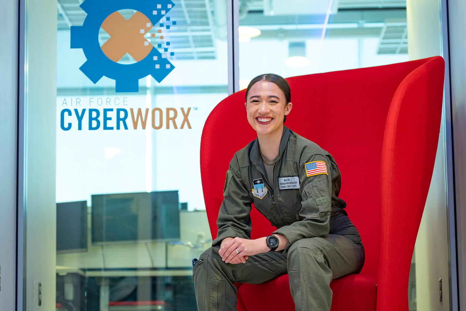Cadet poses for a photo in front of the Cyberworks Lab