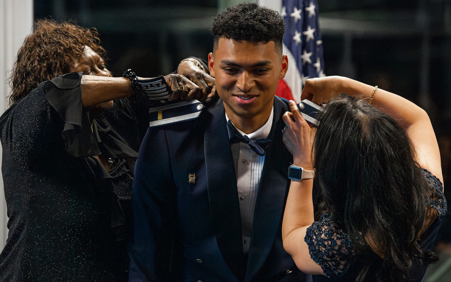 Cadet Flowers receives shoulder boards at a commissioning ceremony.