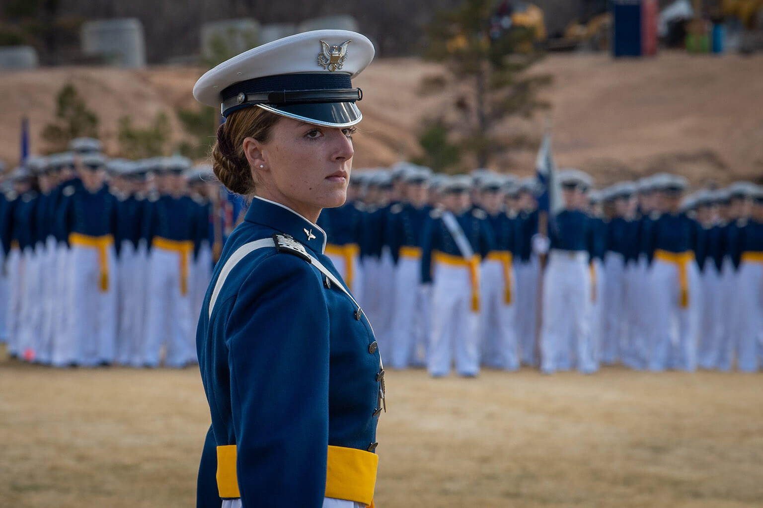 Female cadet in front of parade formation.